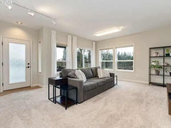 a living room with furniture and a large window