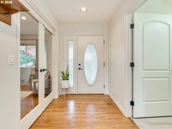 a view of a room with wooden floor and entryway
