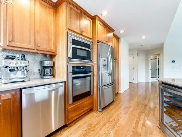 a kitchen with stainless steel appliances granite countertop a refrigerator and a stove top oven