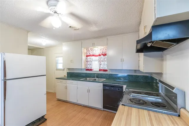 a kitchen with kitchen island a counter top space appliances and cabinets