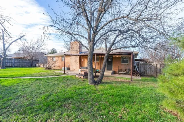 a view of a house with a yard and sitting area