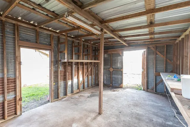 a view of empty room with wooden walls