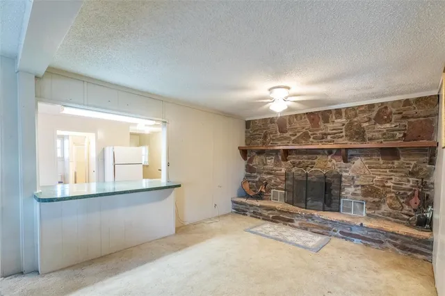 a view of a livingroom with wooden floor and a window