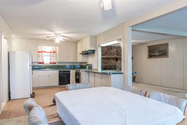 a kitchen with a refrigerator and a stove top oven