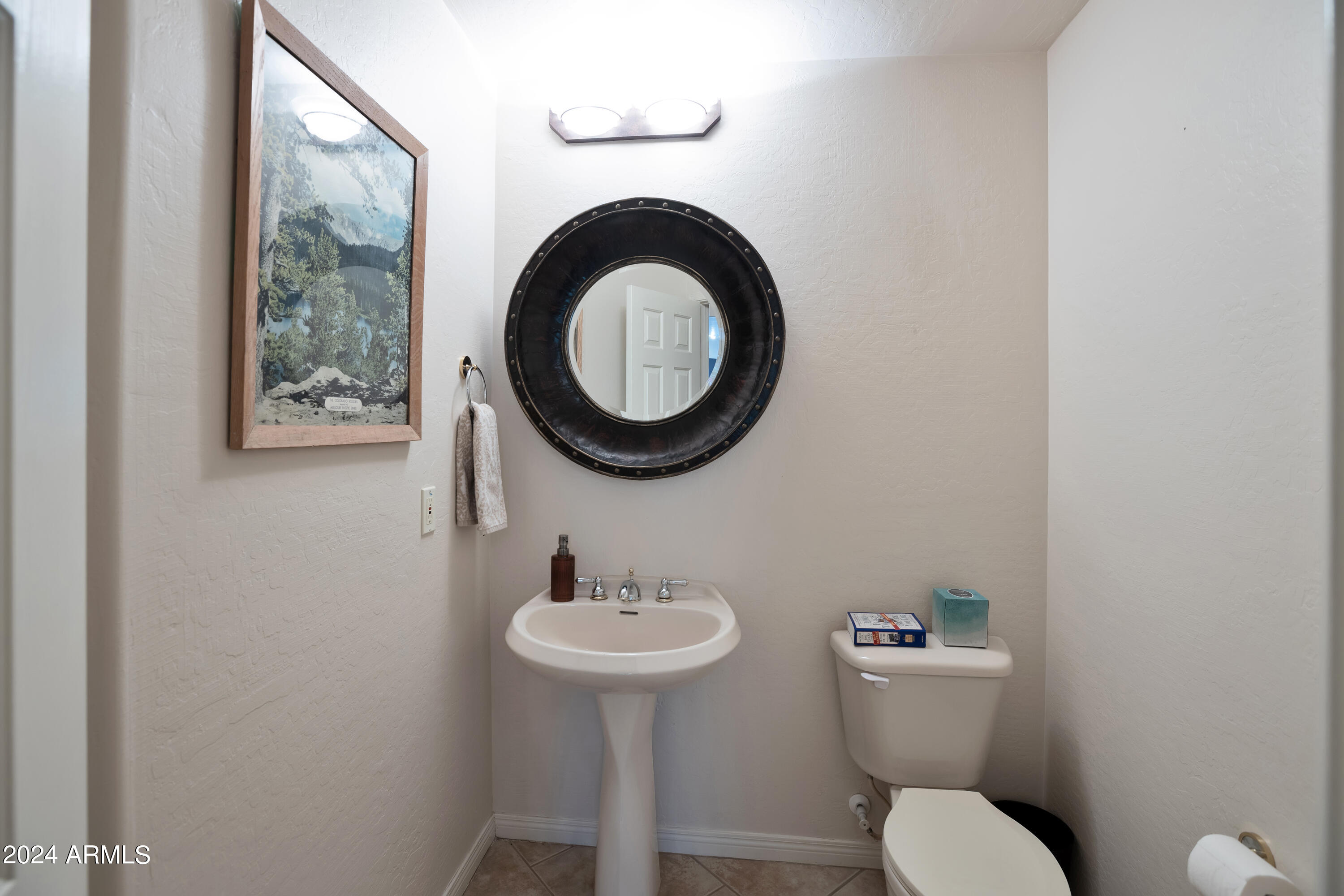 19550 North Grayhawk Drive, Unit 1137 Scottsdale, AZ 85255 - Photo 11 of 48 a bathroom with a toilet sink and mirror