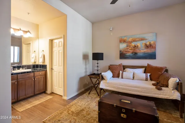 a living room with furniture and a refrigerator