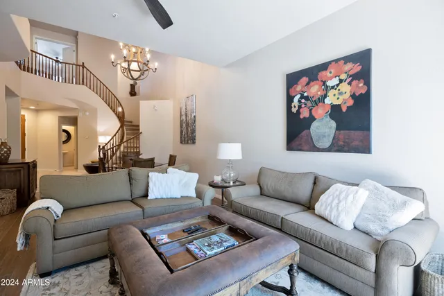 a living room with furniture a rug and a chandelier