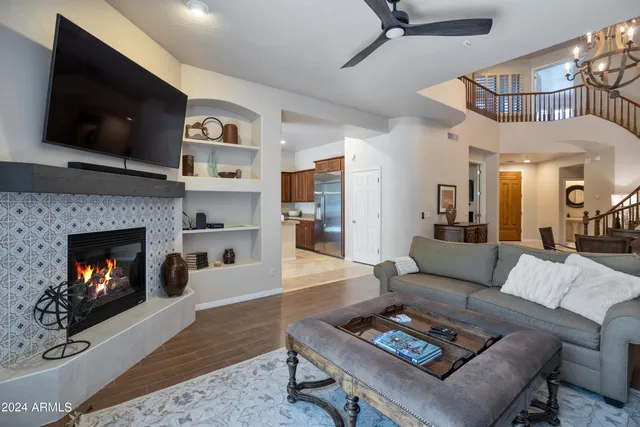 a living room with furniture a flat screen tv and a fireplace