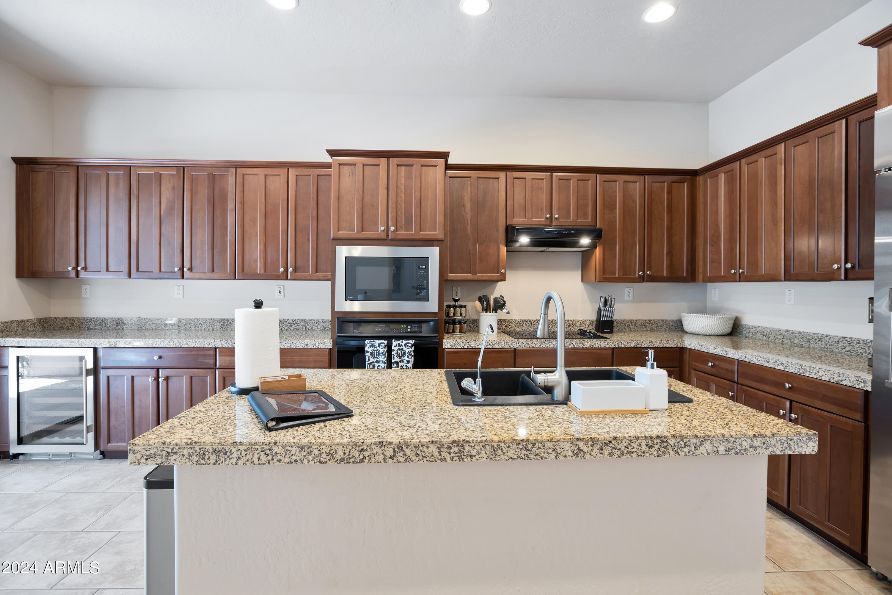19550 North Grayhawk Drive, Unit 1137 Scottsdale, AZ 85255 - Photo 19 of 48 a kitchen with granite countertop a sink a stove and cabinets