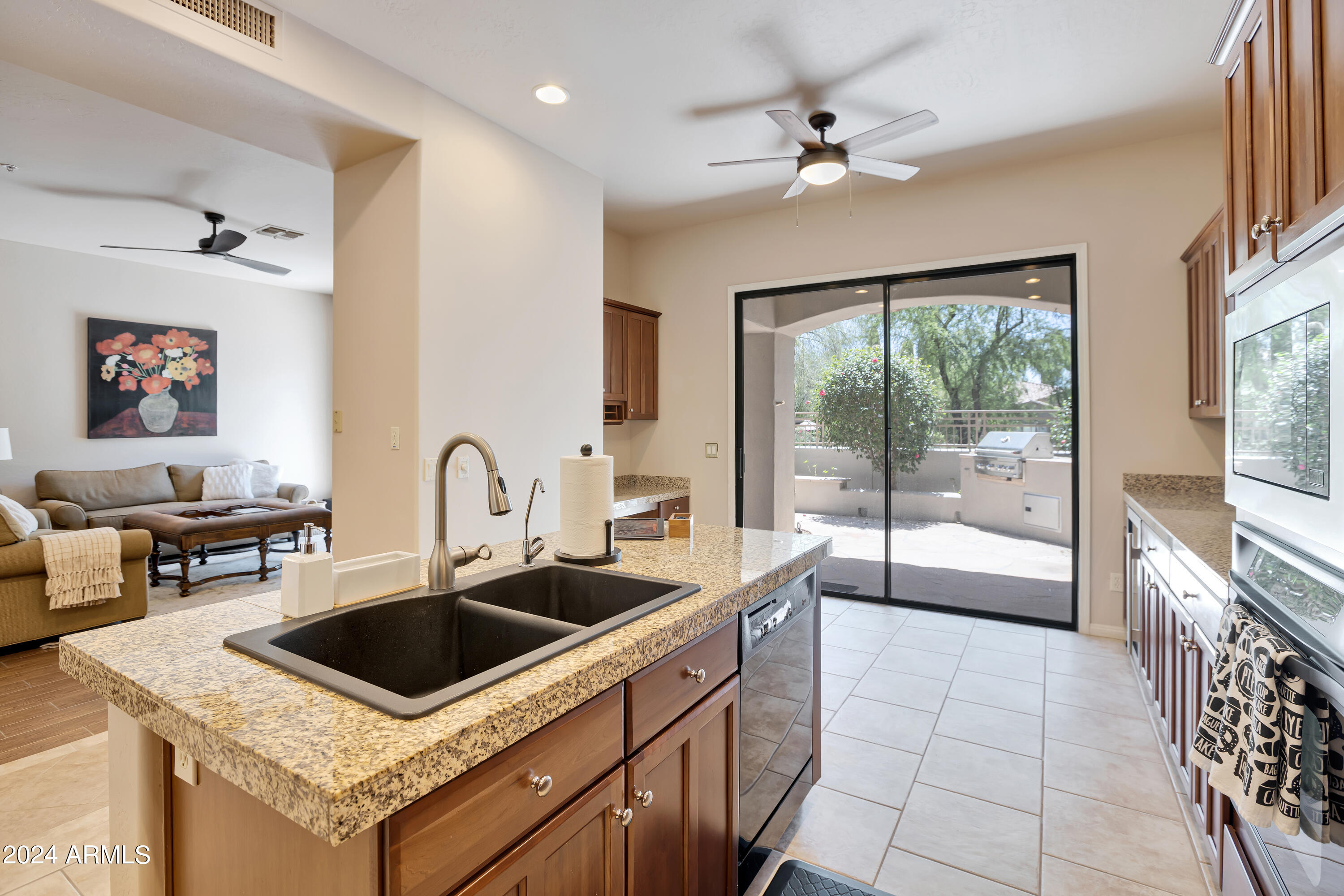 19550 North Grayhawk Drive, Unit 1137 Scottsdale, AZ 85255 - Photo 21 of 48 a kitchen that has a sink a stove and a dining table with the view of kitchen