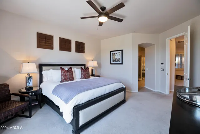 a bedroom with a bed and a chandelier