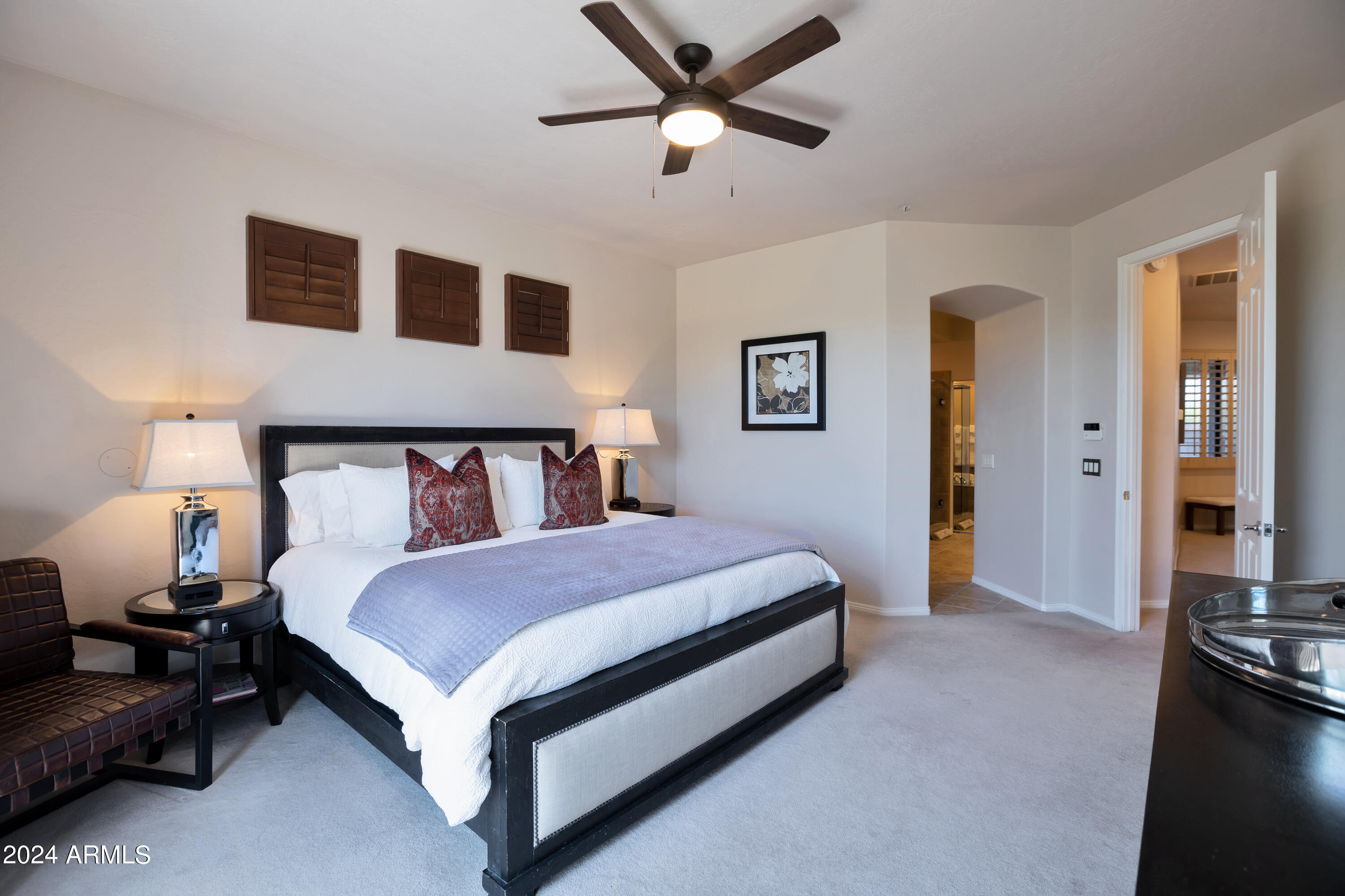 19550 North Grayhawk Drive, Unit 1137 Scottsdale, AZ 85255 - Photo 25 of 48 a bedroom with a bed and a chandelier