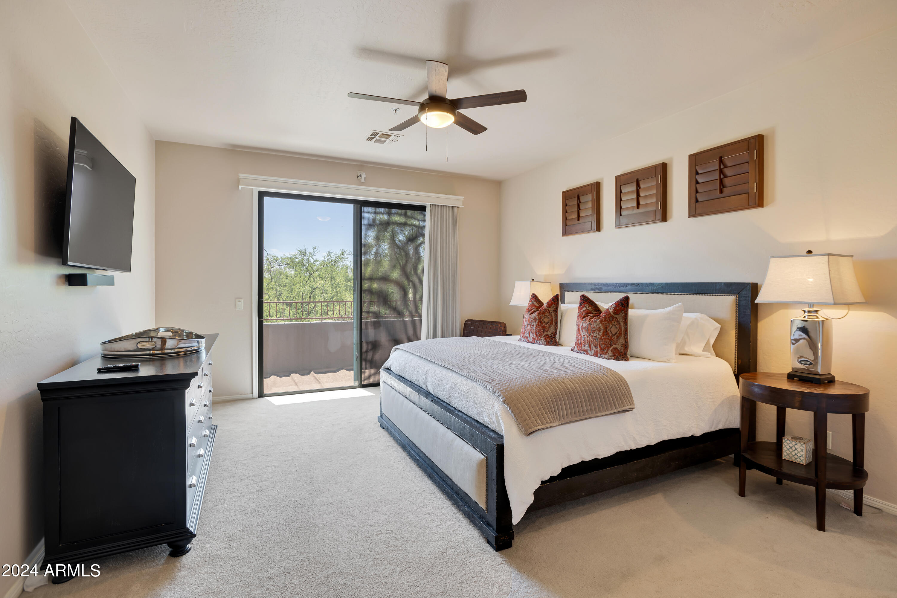 19550 North Grayhawk Drive, Unit 1137 Scottsdale, AZ 85255 - Photo 26 of 48 a spacious bedroom with a bed and a flat screen tv