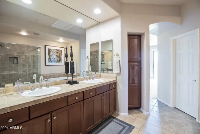 a bathroom with a double vanity sink and a mirror