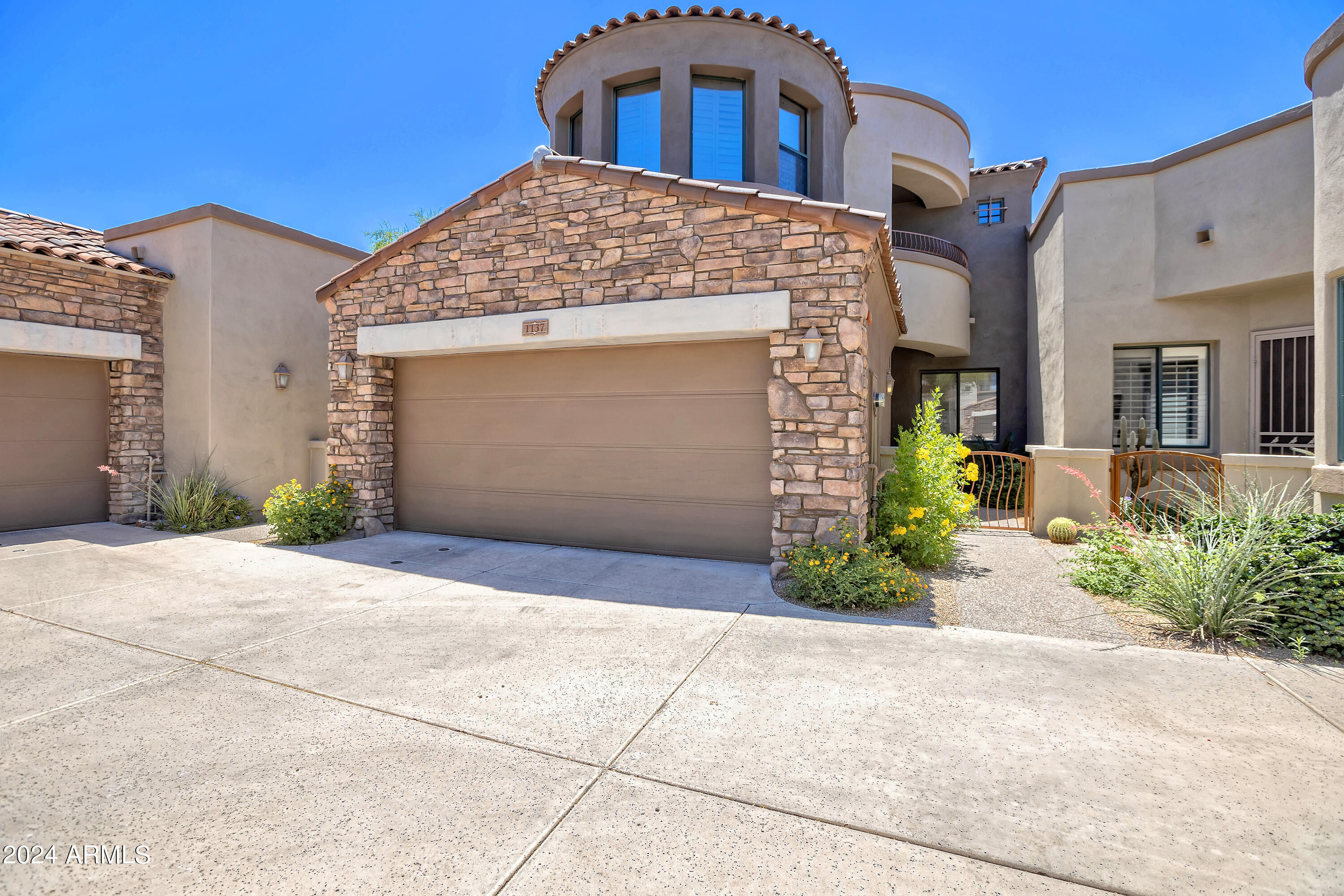 19550 North Grayhawk Drive, Unit 1137 Scottsdale, AZ 85255 - Photo 3 of 48 a front view of a house with garden