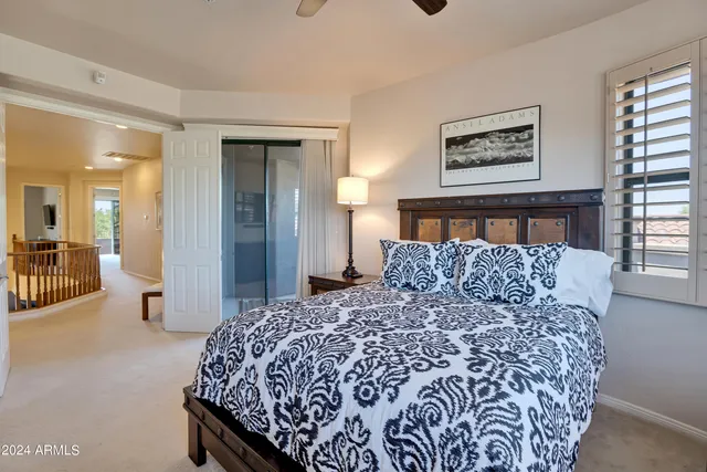 a large bed in a bedroom and a mirror