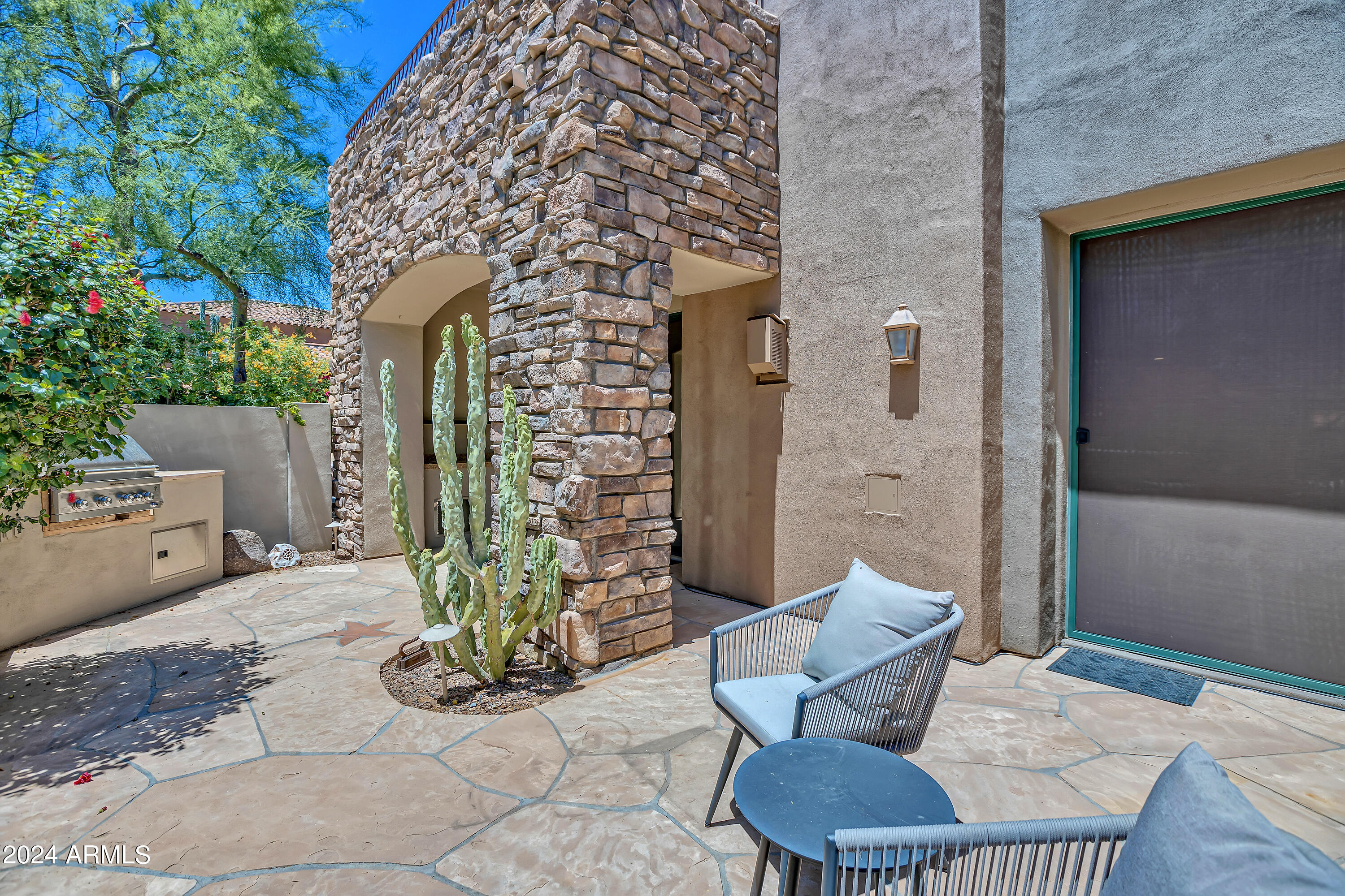 19550 North Grayhawk Drive, Unit 1137 Scottsdale, AZ 85255 - Photo 35 of 48 a view of a patio with couple of chairs and a potted plant
