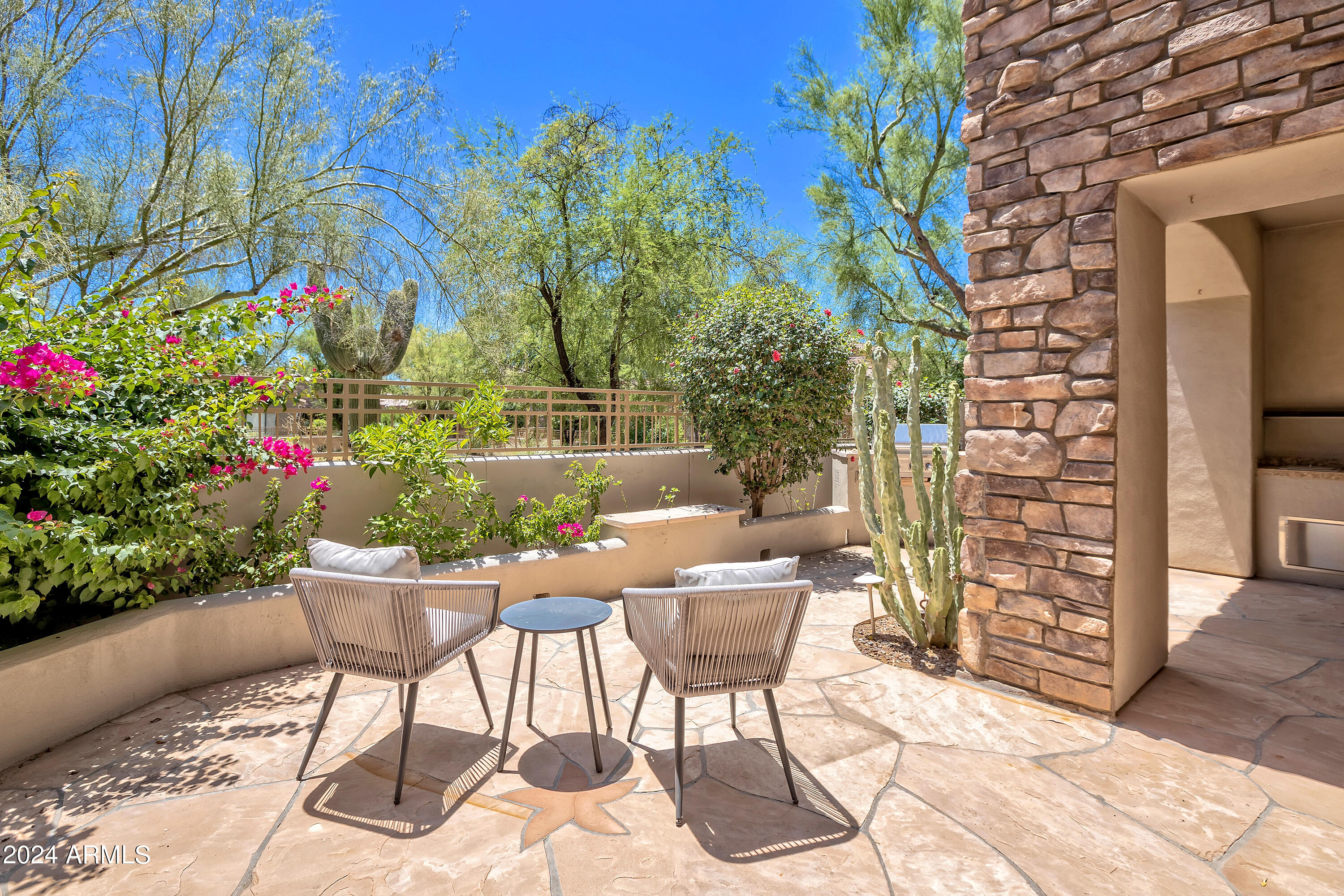 19550 North Grayhawk Drive, Unit 1137 Scottsdale, AZ 85255 - Photo 36 of 48 a patio with table and chairs and potted plants