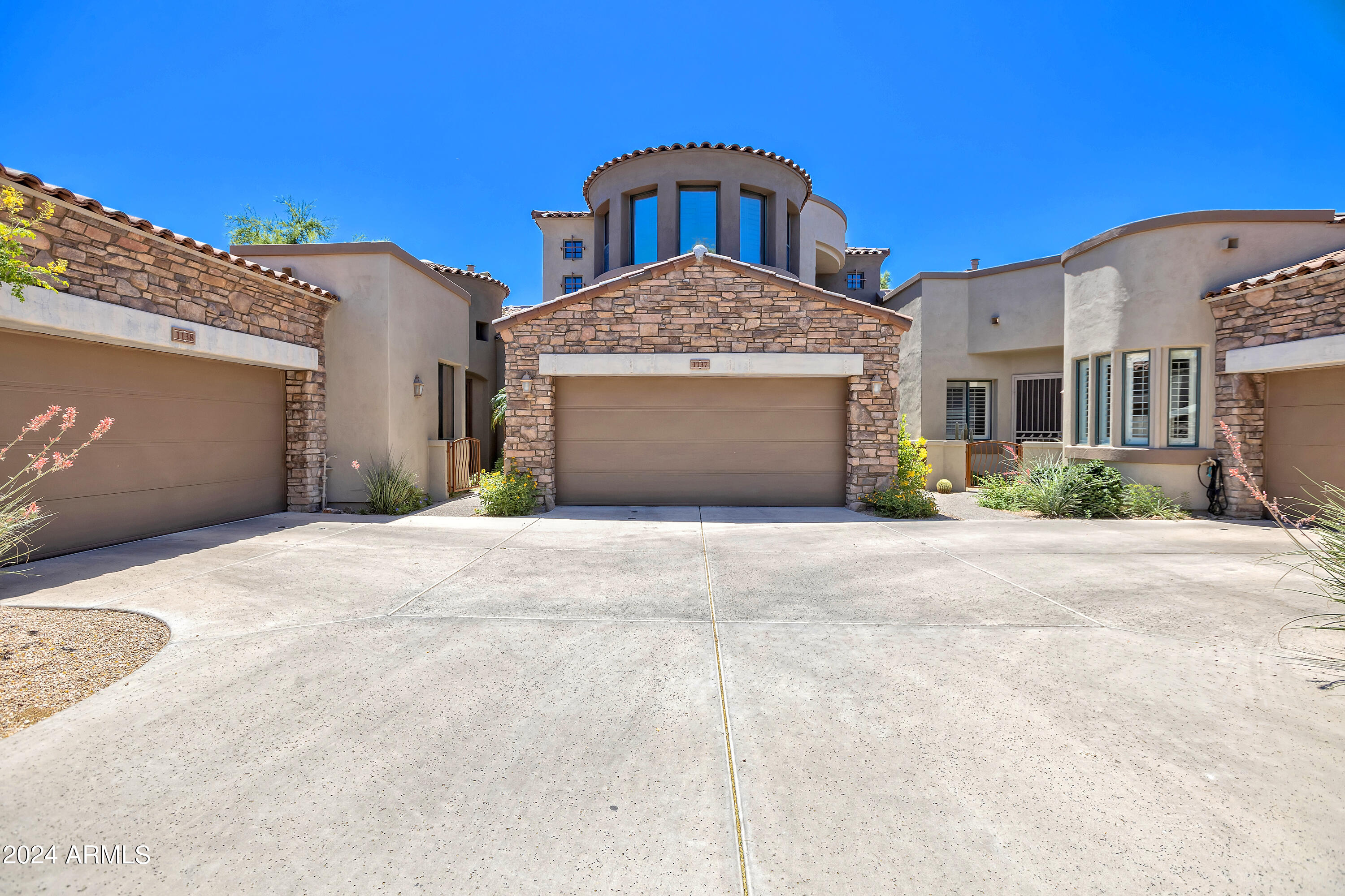 19550 North Grayhawk Drive, Unit 1137 Scottsdale, AZ 85255 - Photo 4 of 48 a front view of a house with a yard and garage