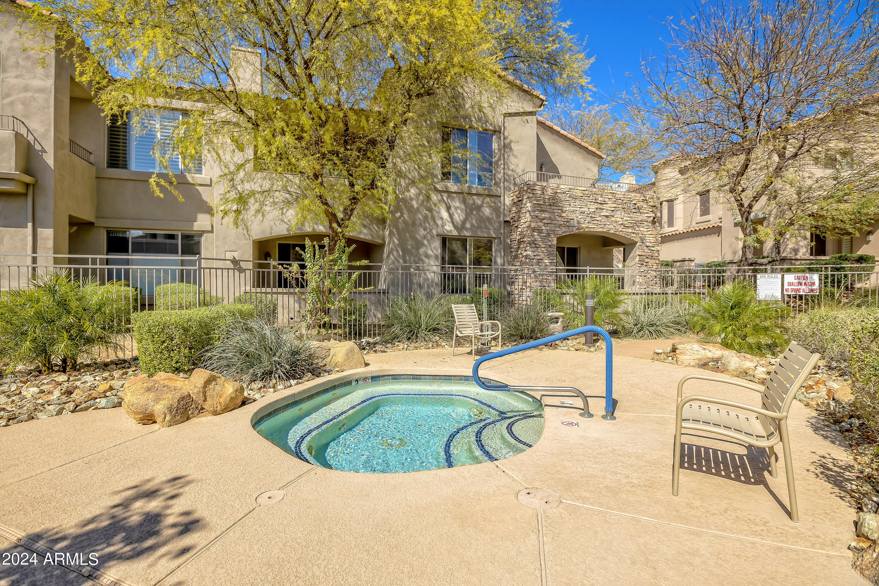 19550 North Grayhawk Drive, Unit 1137 Scottsdale, AZ 85255 - Photo 42 of 48 a view of a swimming pool with a lounge chairs
