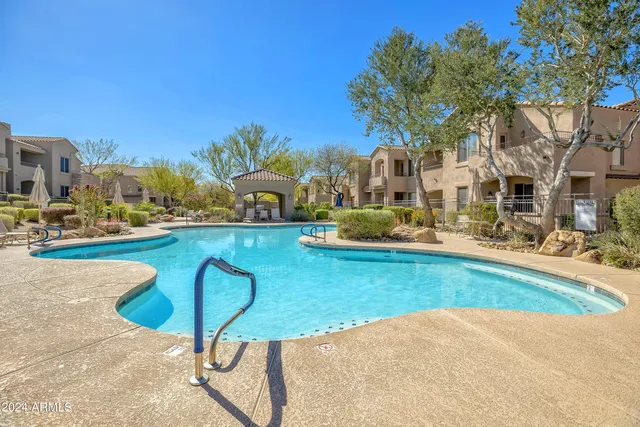 a view of a swimming pool with outdoor seating