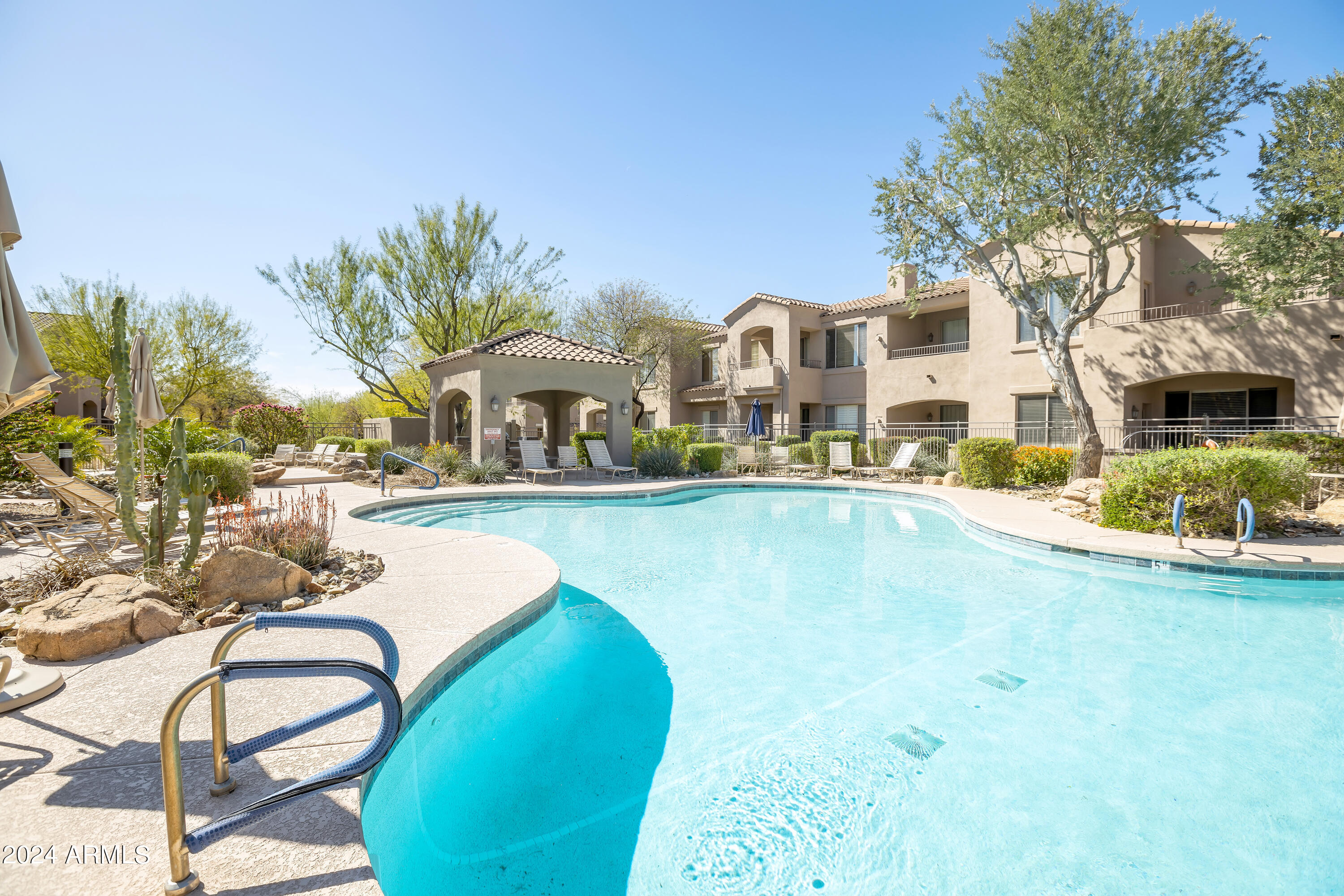 19550 North Grayhawk Drive, Unit 1137 Scottsdale, AZ 85255 - Photo 44 of 48 a swimming pool with outdoor seating and yard