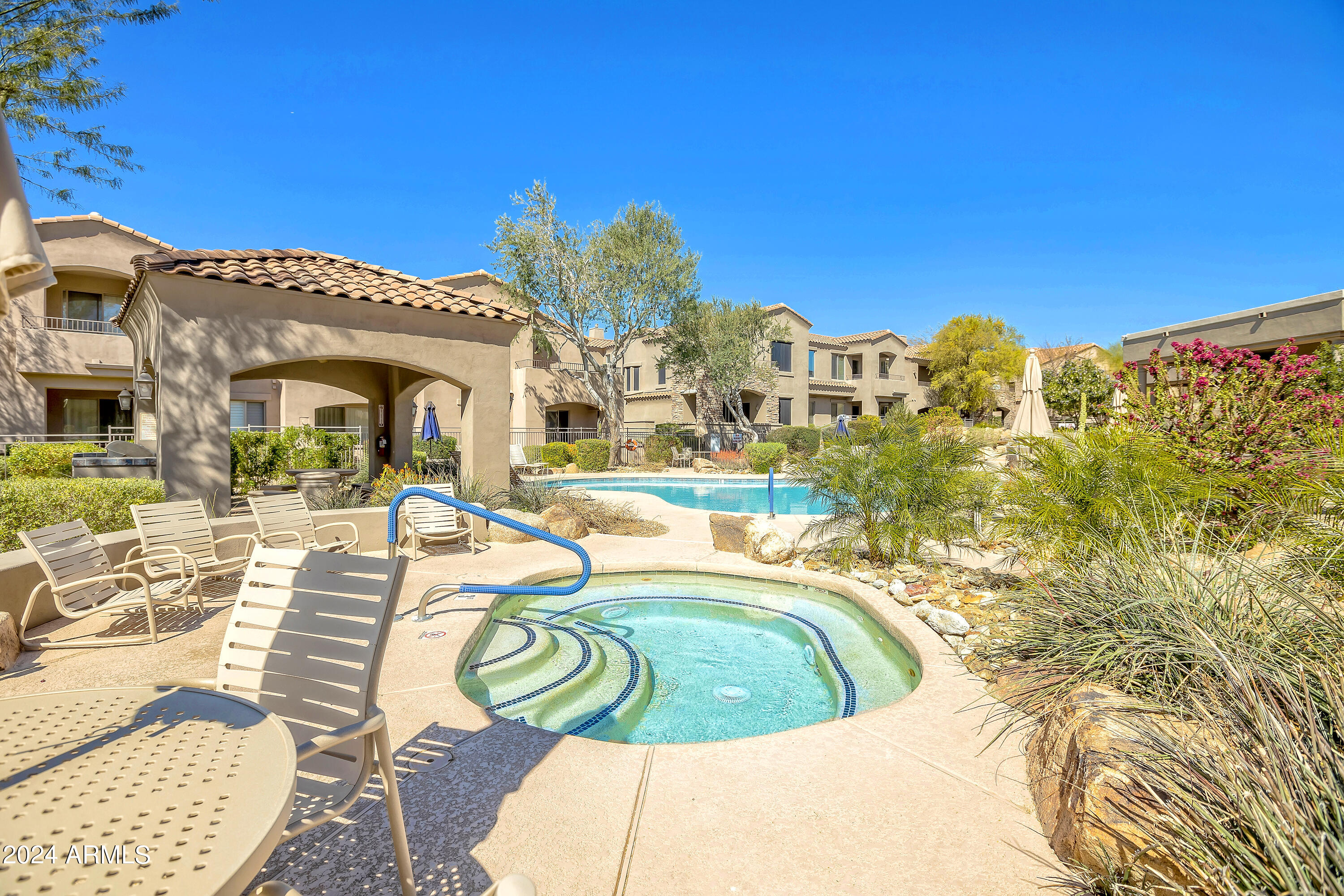 19550 North Grayhawk Drive, Unit 1137 Scottsdale, AZ 85255 - Photo 45 of 48 a view of a swimming pool with outdoor seating