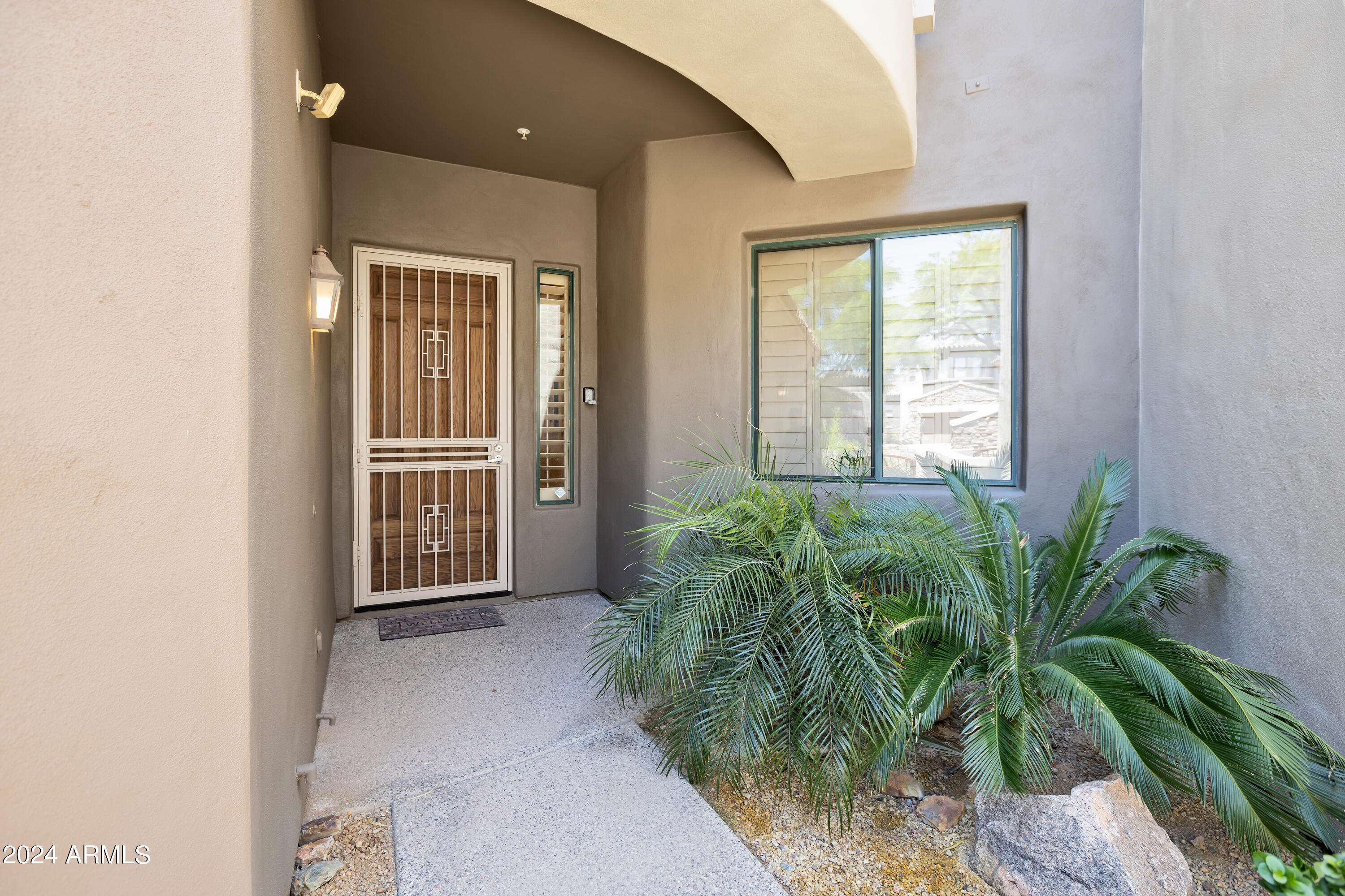 19550 North Grayhawk Drive, Unit 1137 Scottsdale, AZ 85255 - Photo 5 of 48 a view of a room with potted plants and wooden fence