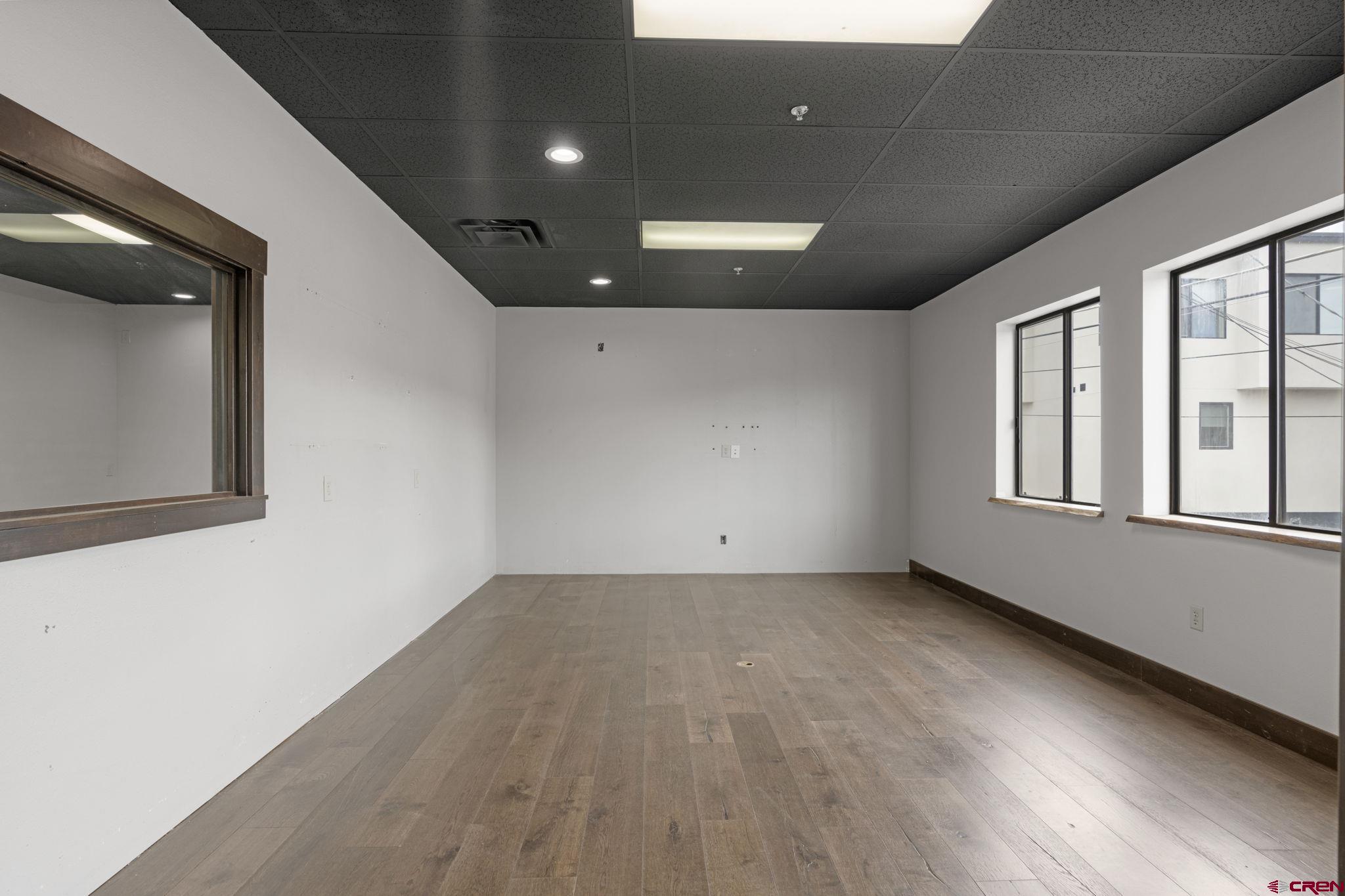 3206 Main Avenue, Unit 4 Durango, CO 81301 - Photo 6 of 18 an empty room with wooden floor and windows