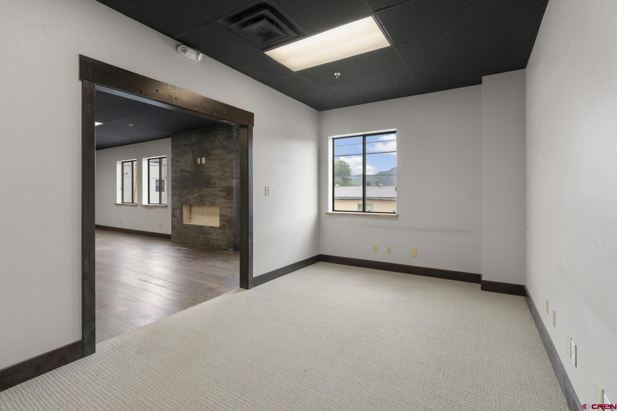 3206 Main Avenue, Unit 4 Durango, CO 81301 - Photo 9 of 18 an empty room with wooden floor and windows