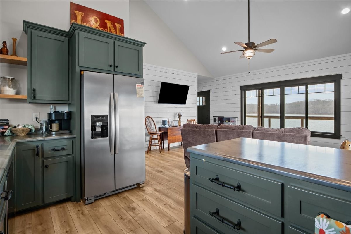 269 Paradise Lane Stewart, TN 37175 - Photo 16 of 31 a kitchen with stainless steel appliances granite countertop a refrigerator a stove and a sink with wooden floor