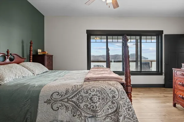 a bedroom with a large bed and a large window