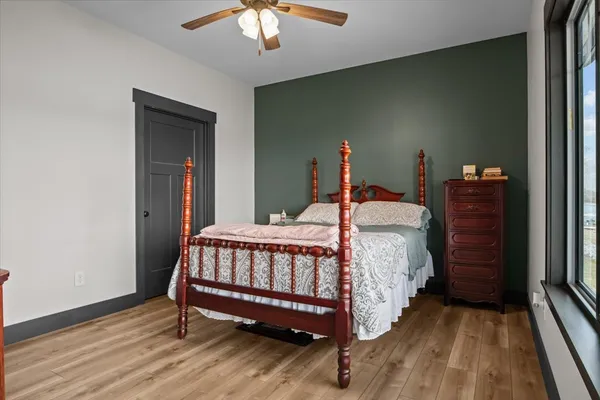 a bed sitting in a bedroom next to a window