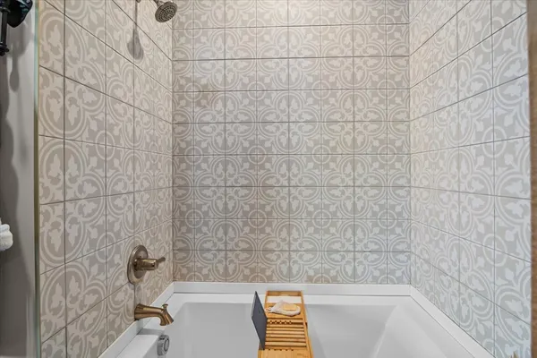 a bathroom with a bathtub and shower