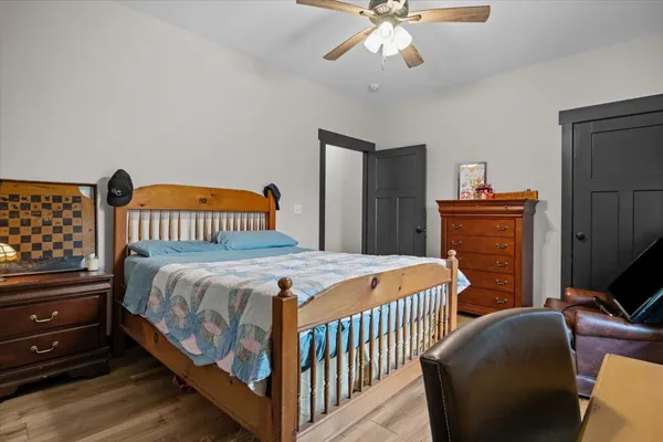 a bedroom with a bed and a chandelier