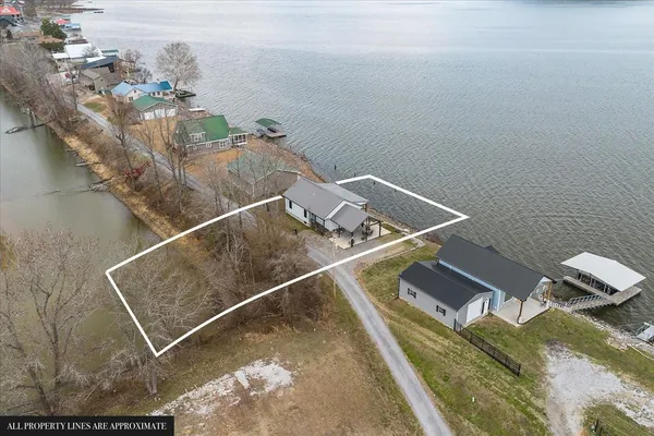 a room with water heater and wooden cabinets