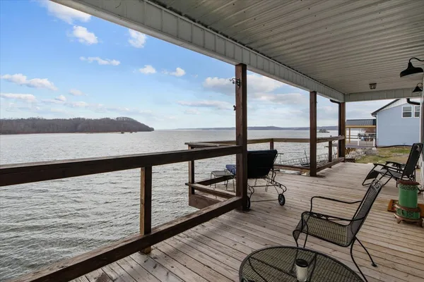 a view of a balcony with chairs and wooden floor
