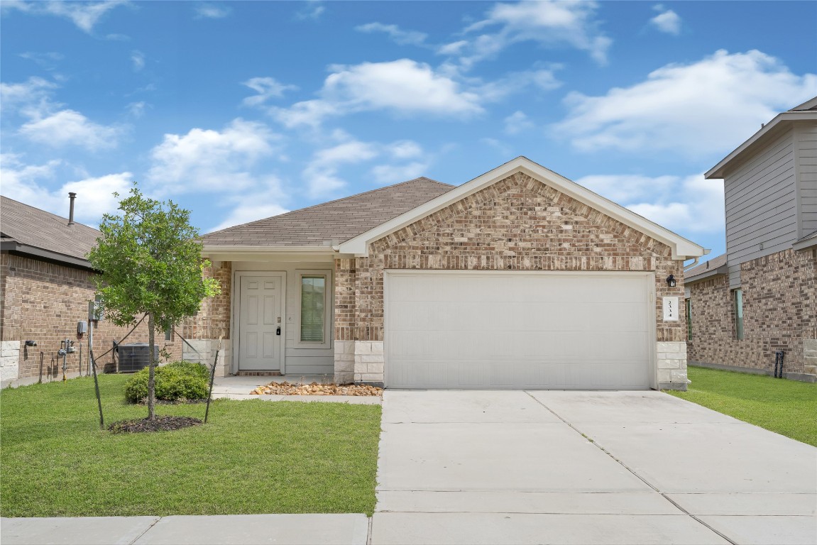 a view of a house with a yard and garage