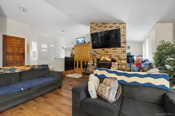 a living room with fireplace furniture and a flat screen tv