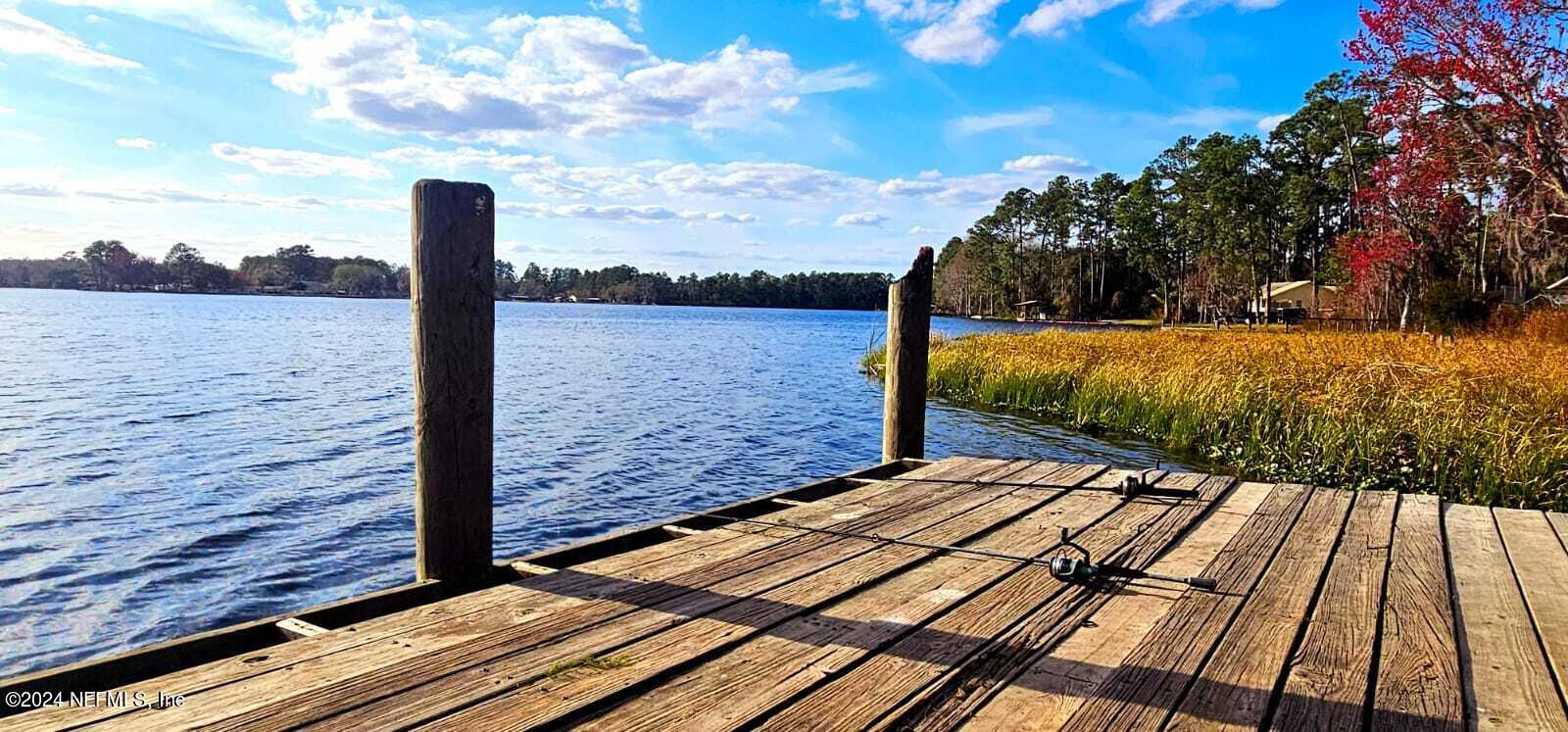0 Lily Trail Interlachen, FL 32148 - Photo 18 of 22 a view of a balcony with wooden floor and fence