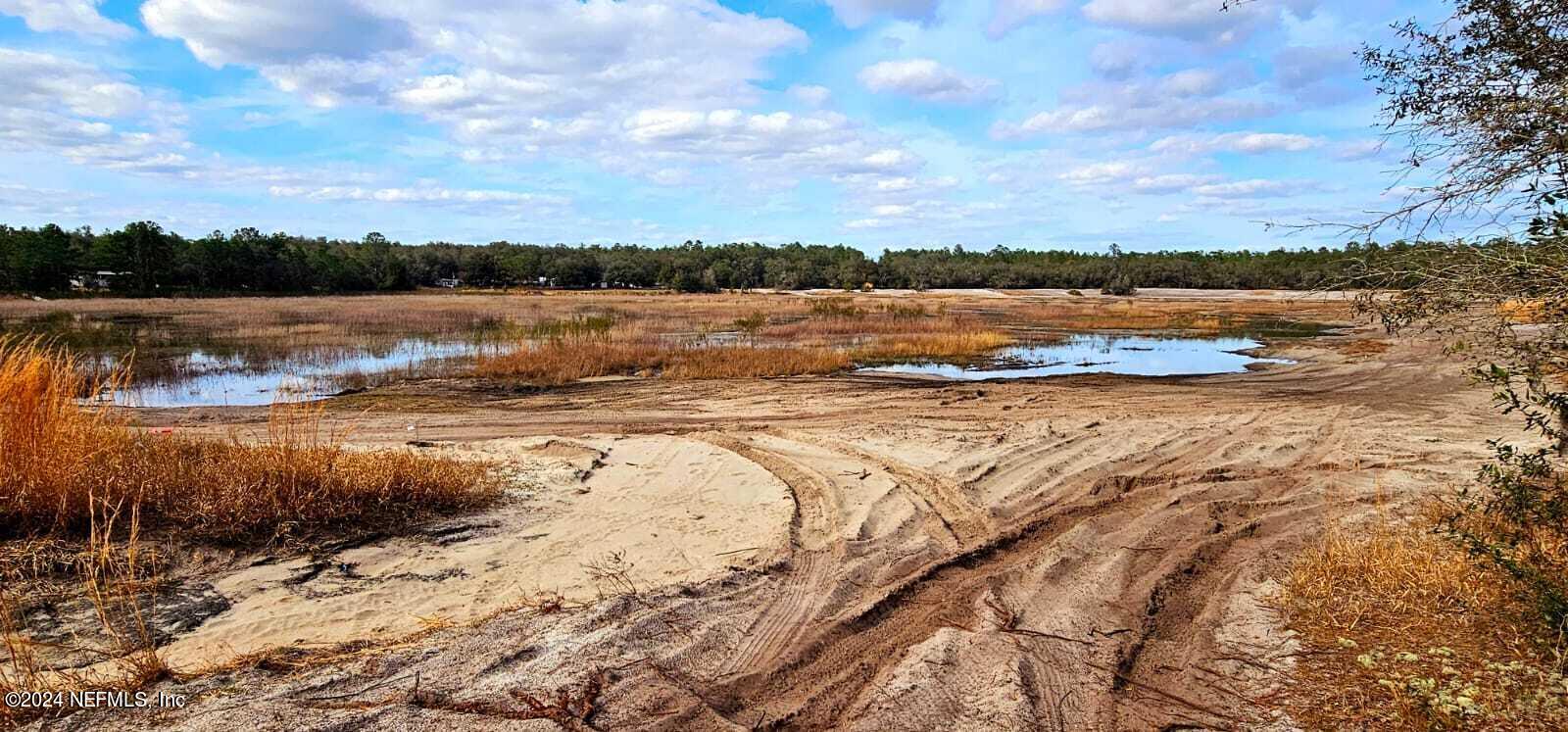 0 Lily Trail Interlachen, FL 32148 - Photo 9 of 22 a view of a lake with houses in the background