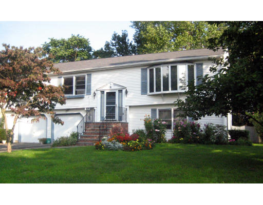 55 Staniford Street Newton, MA 02466 - Photo 1 of 17 a front view of a house with a garden and plants