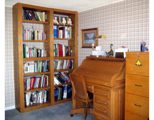 55 Staniford Street Newton, MA 02466 - Photo 13 of 17 a dining room with a table and a book shelf