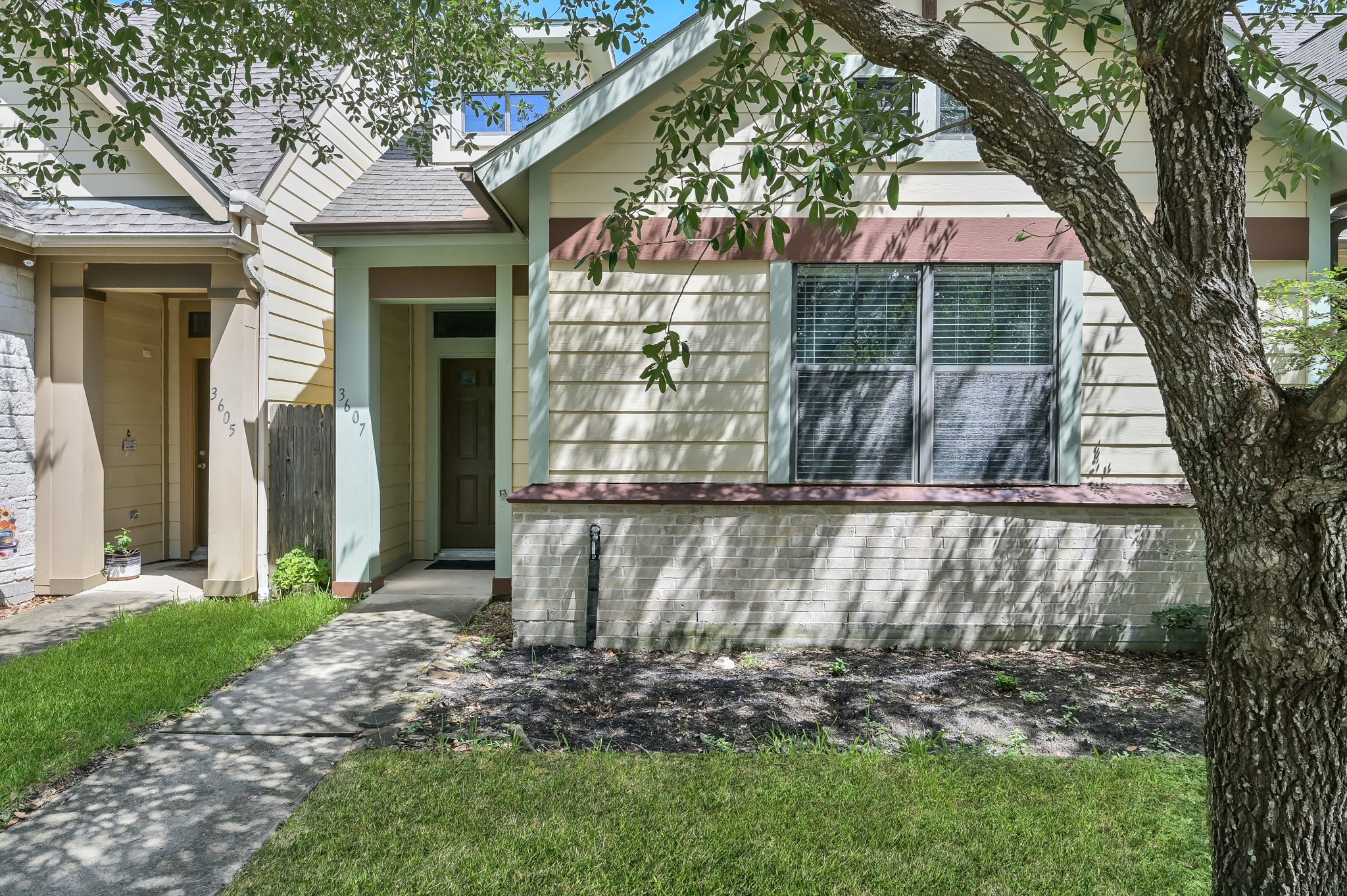 3607 Cedar Flats Lane Spring, TX 77386 - Photo 2 of 41 a view of a small yard in front of a house with large tree and plants