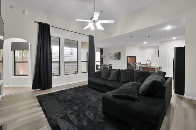 a living room with furniture and a chandelier