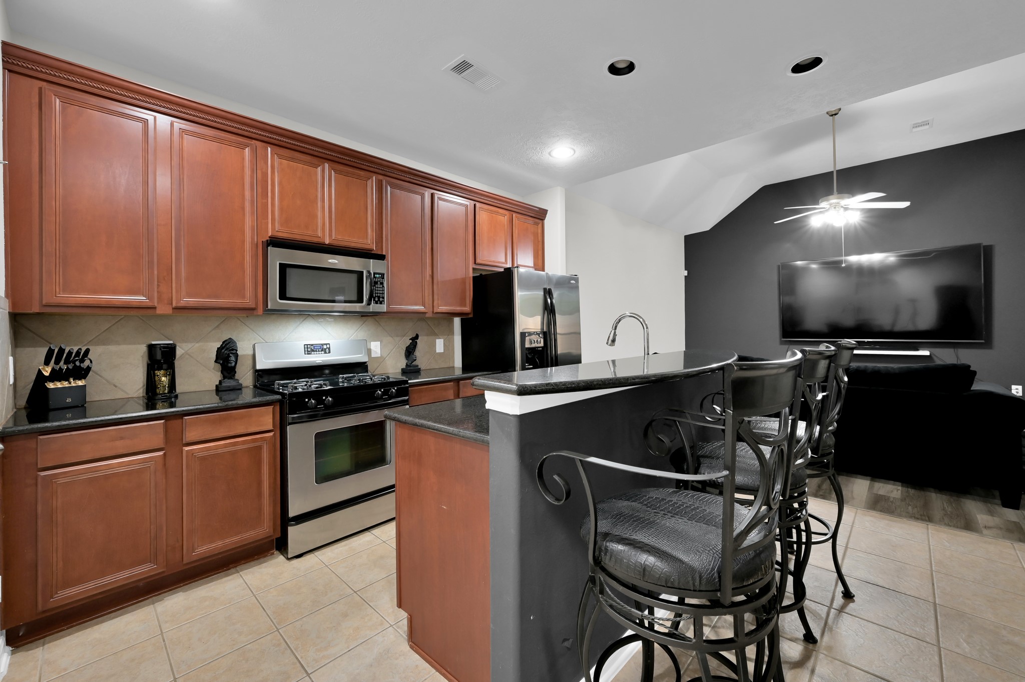 3607 Cedar Flats Lane Spring, TX 77386 - Photo 8 of 41 a kitchen with stainless steel appliances granite countertop a stove top oven a sink dishwasher a dining table and chairs with wooden floor