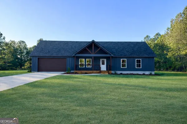 a front view of a house with a garden