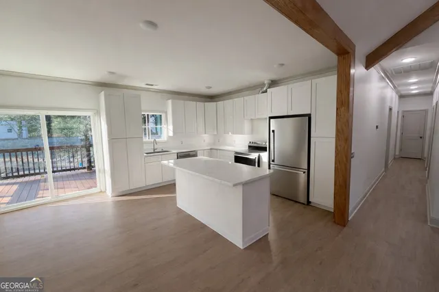 a kitchen with stainless steel appliances a refrigerator and a stove top oven