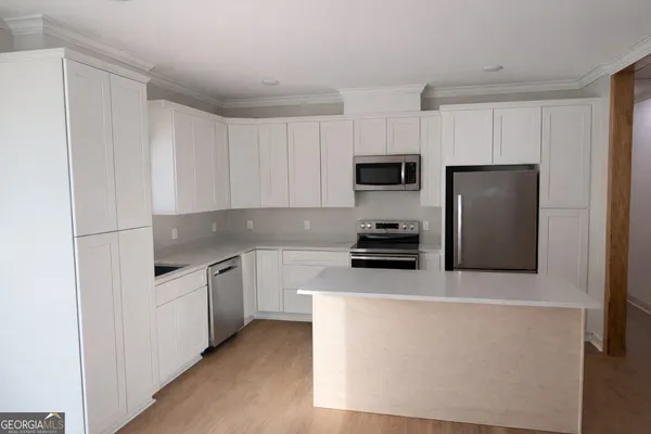 a kitchen with stainless steel appliances a refrigerator sink and microwave
