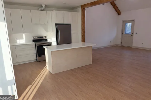 a kitchen with a refrigerator and a stove